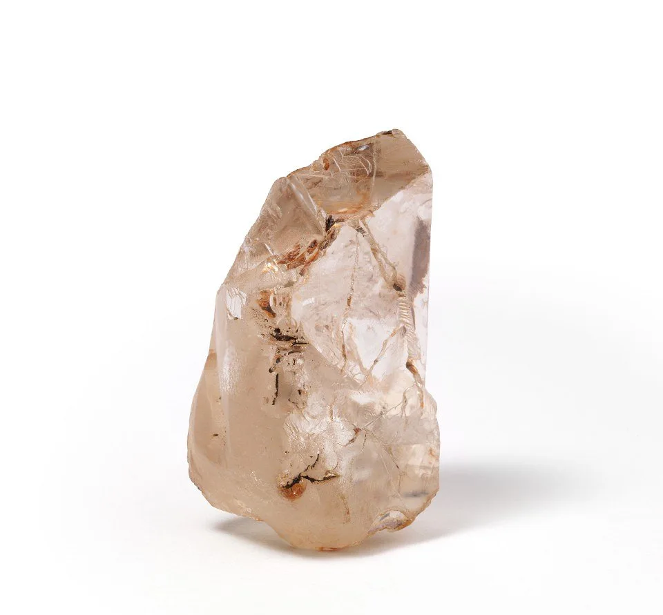 A rough, uncut diamond crystal, showing its natural unpolished form as it emerges from deep within the Earth's mantle